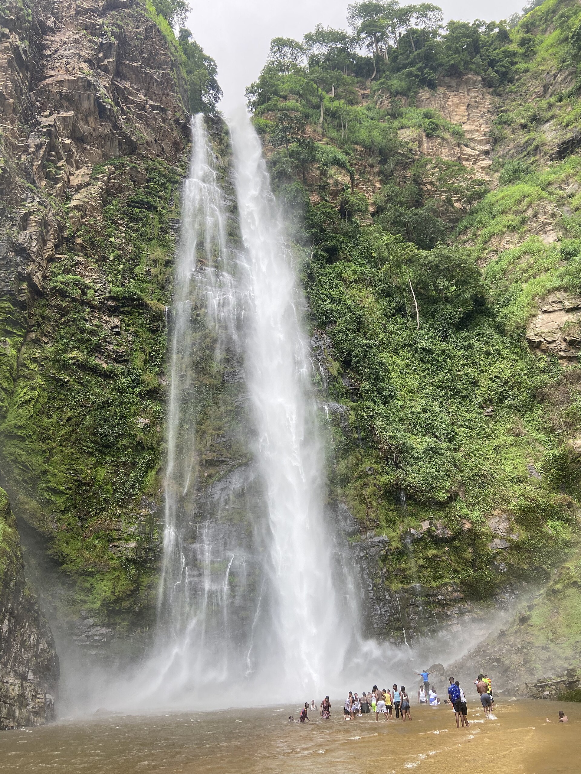 Wli Waterfalls surrounded by green rock and forest